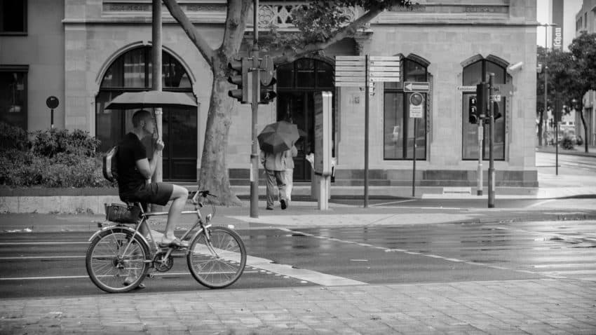 Man cycling in the rain.