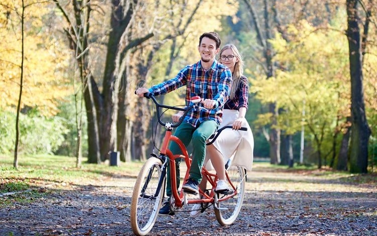 young couple on tandem bike